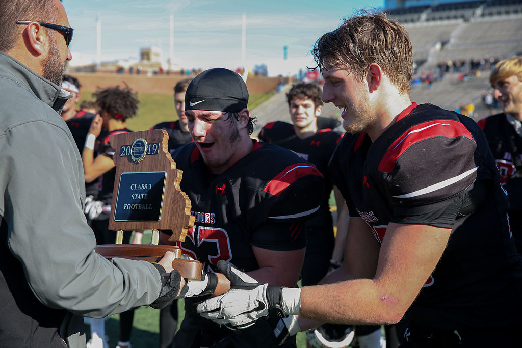 Odessa Garrett Sims and Colby Wilson and 50 accept trophy during the game against Cassville High School